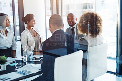 Buy stock photo Shot of a team of professionals having a meeting in the boardroom at work