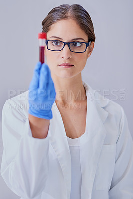 Buy stock photo Shot of a scientist examining a medical sample while standing in a laboratory