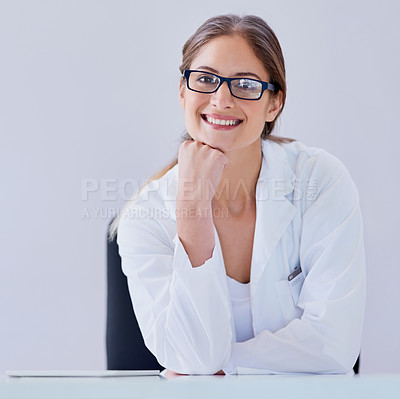Buy stock photo Portrait of a smiling scientist sitting at a desk