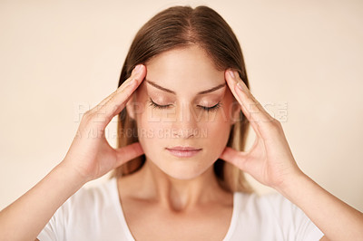 Buy stock photo Cropped shot of a young woman experiencing a headache