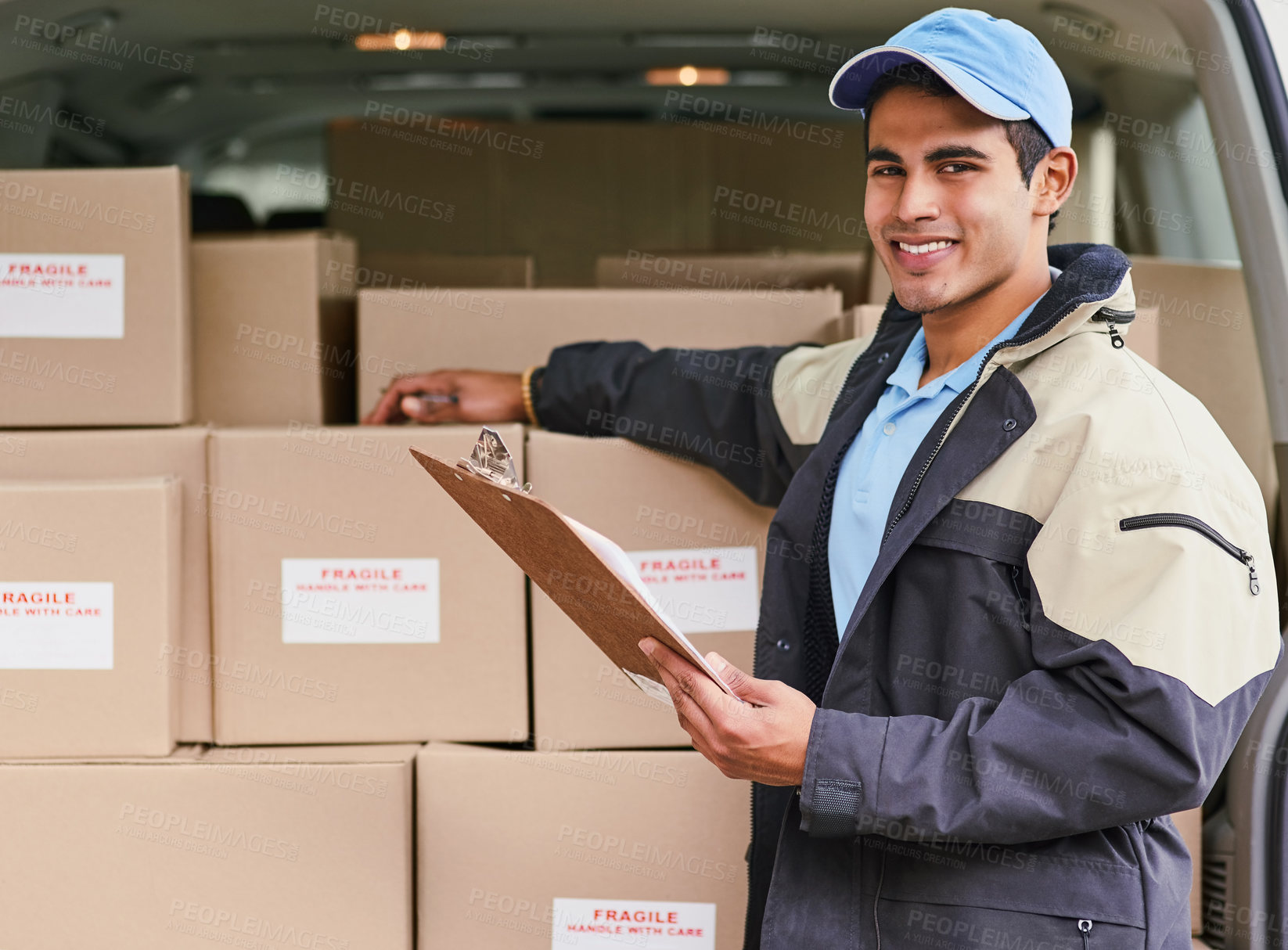 Buy stock photo Portrait of a delivery man standing next to a van full of boxes