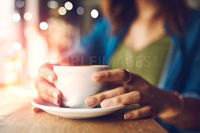 Buy stock photo Closeup shot of an unrecognizable woman having a cup of coffee at a cafe