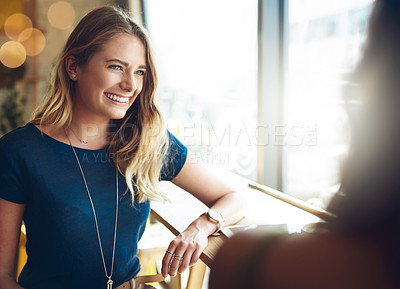 Buy stock photo Cropped shot of a woman chatting to her friend in a cafe