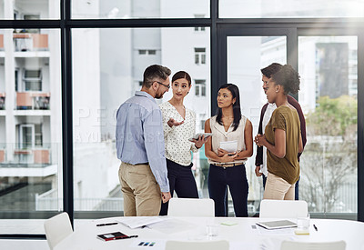Buy stock photo Shot of a group of businesspeople having a discussion in a modern office