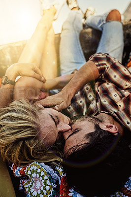 Buy stock photo Shot of a young couple lying at the back of a pickup truck to relax after a long drive