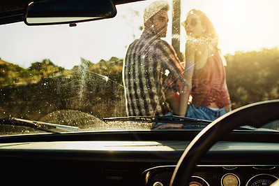 Buy stock photo Shot of a young couple out on a road trip with their truck