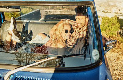 Buy stock photo Shot of a young couple out on a road trip with their truck