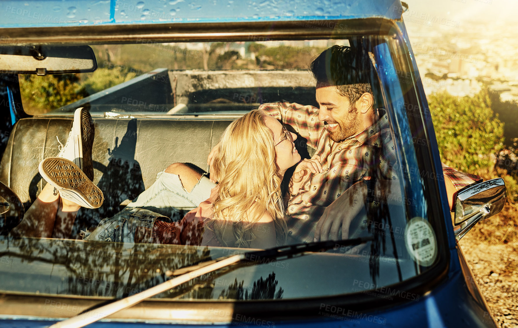 Buy stock photo Shot of a young couple out on a road trip with their truck