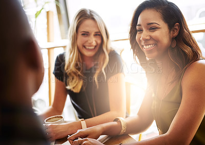 Buy stock photo Shot of a group of friends catching up over coffee in a coffee shop