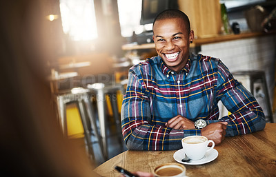 Buy stock photo Shot of a man having coffee with a friend in a coffee shop