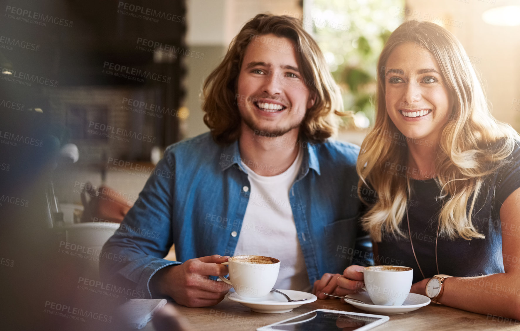 Buy stock photo Shot of a couple enjoying a double date with friends in a coffee shop