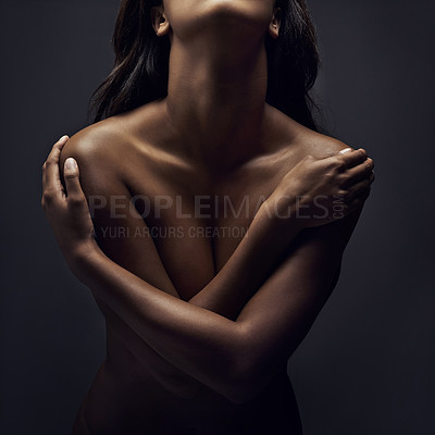 Buy stock photo Shot of a beautiful woman posing nude in the studio