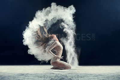 Buy stock photo Studio shot of a young woman leaving a trail of powder in the air by whipping her hair