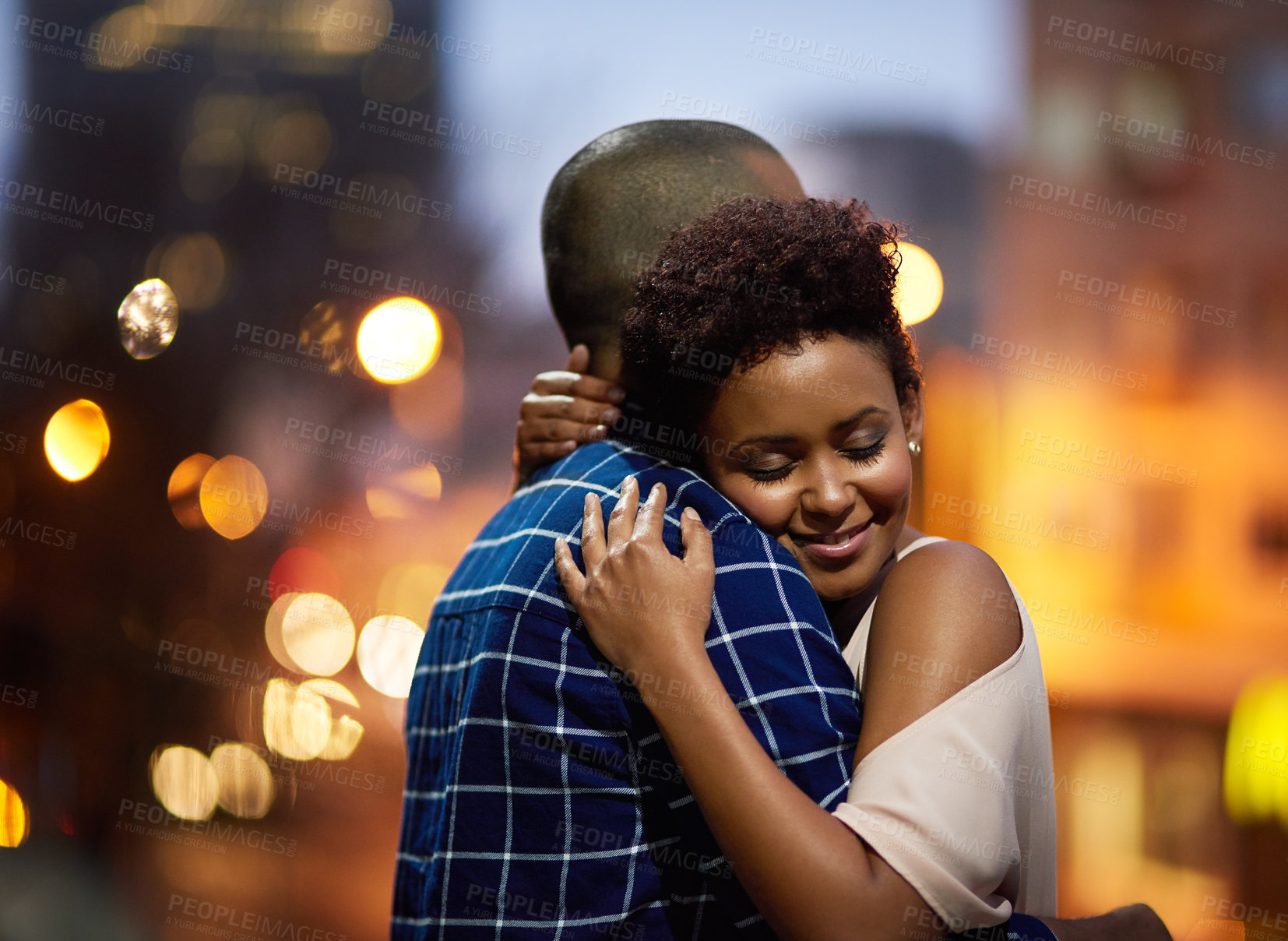 Buy stock photo Cropped shot of an affectionate young couple out on a date in the city