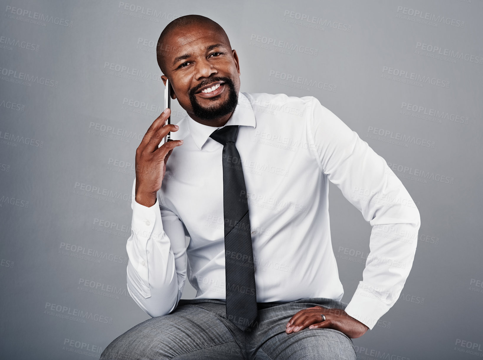 Buy stock photo Portrait, professional and black man with phone call of management consultant in studio. Corporate, entrepreneur and sitting executive with leader and networking for business with grey background