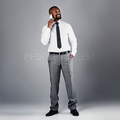 Buy stock photo Studio shot of a corporate businessman talking on his cellphone against a grey background