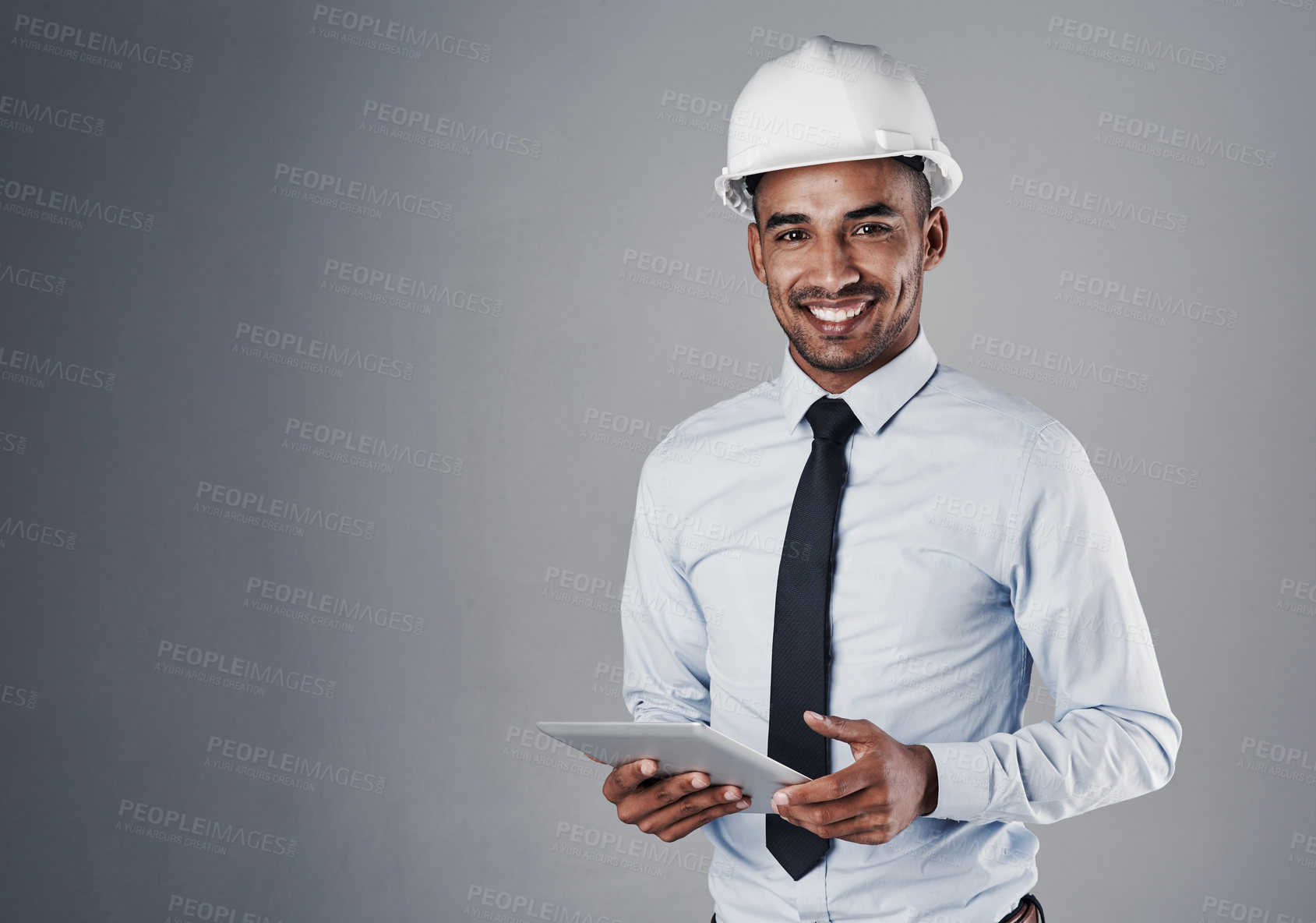 Buy stock photo Engineer, tablet and portrait of construction worker with research and online blueprint in studio. Contractor, plan and helmet of Indian male professional with web scroll, mockup and grey background