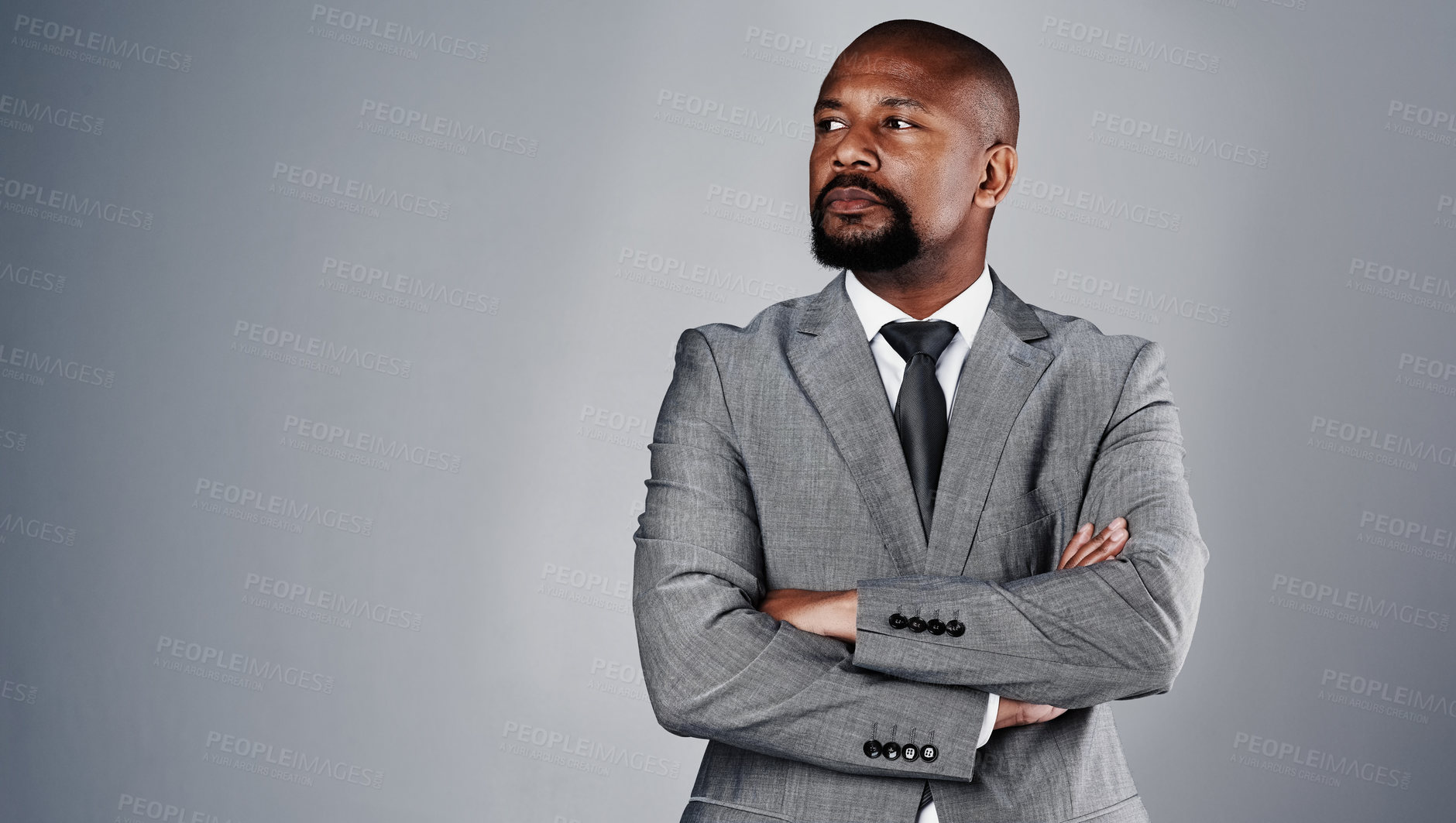 Buy stock photo Studio shot of a corporate businessman posing against a grey background