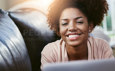 Buy stock photo Portrait of an attractive young woman using laptop while chilling at home on the sofa