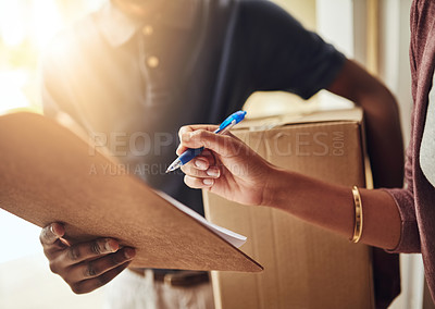 Buy stock photo Cropped shot of an unrecognizable woman signing for a home delivery