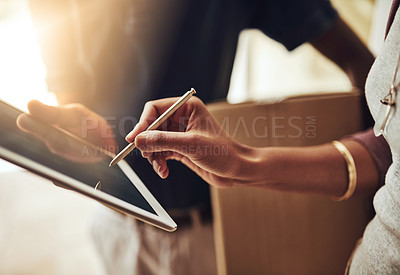 Buy stock photo High angle shot of an unrecognizable woman signing for a home delivery