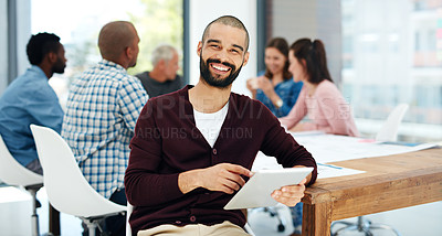 Buy stock photo Portrait of a handsome young man using his tablet while sitting in the boardroom during a meeting