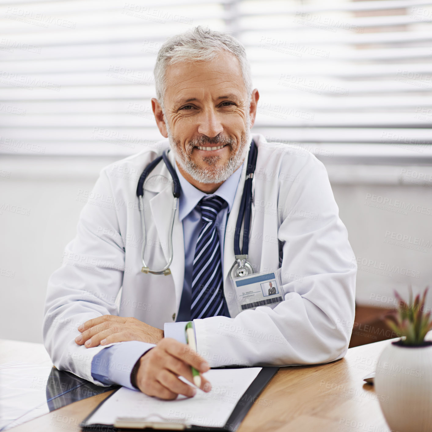 Buy stock photo Mature man, doctor and portrait in office with pride for hospital, medicine and document. Prescription, stethoscope and paperwork for medical, health insurance insurance and admin with smile 