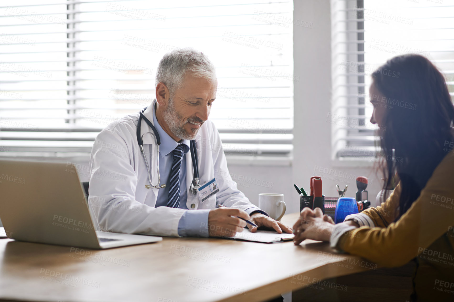 Buy stock photo Doctor, paperwork and talking to a woman patient at hospital for a consultation or health insurance. A man listening to a happy female person in office for signature consent, support or medical help