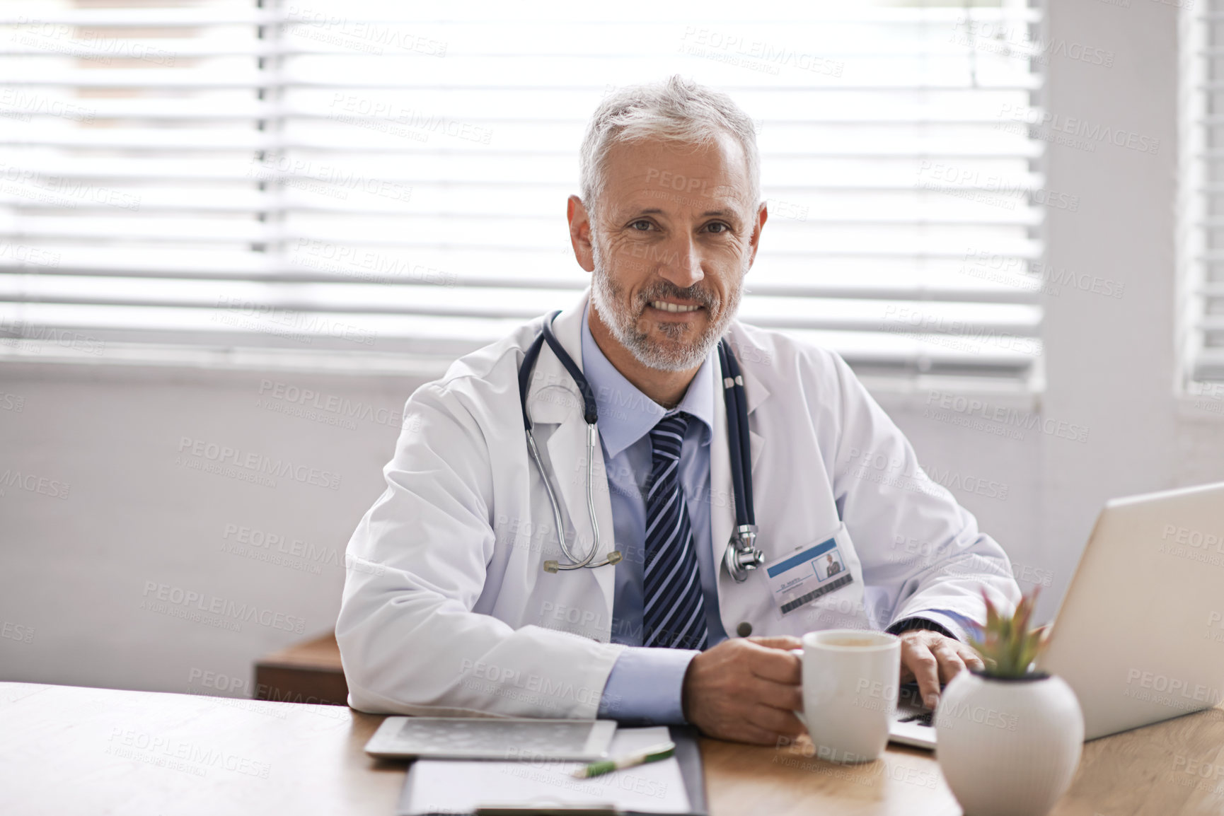 Buy stock photo Healthcare, coffee and portrait of doctor on laptop in office for medical results, research and online consulting. Clinic, hospital and mature man on computer for telehealth, service and wellness