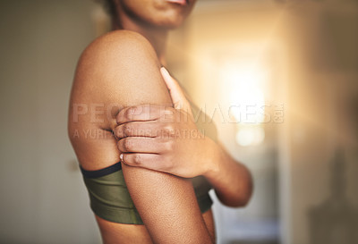 Buy stock photo Shot of a young sporty woman with a sports injury