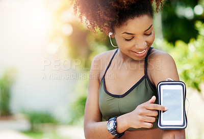 Buy stock photo Cropped shot of a young woman starting her playlist before her run