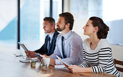Buy stock photo Shot of a group of colleagues listening to a presentation in an office