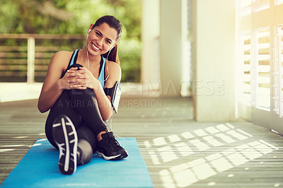 Buy stock photo Portrait of a sporty young woman sitting on her yoga mat