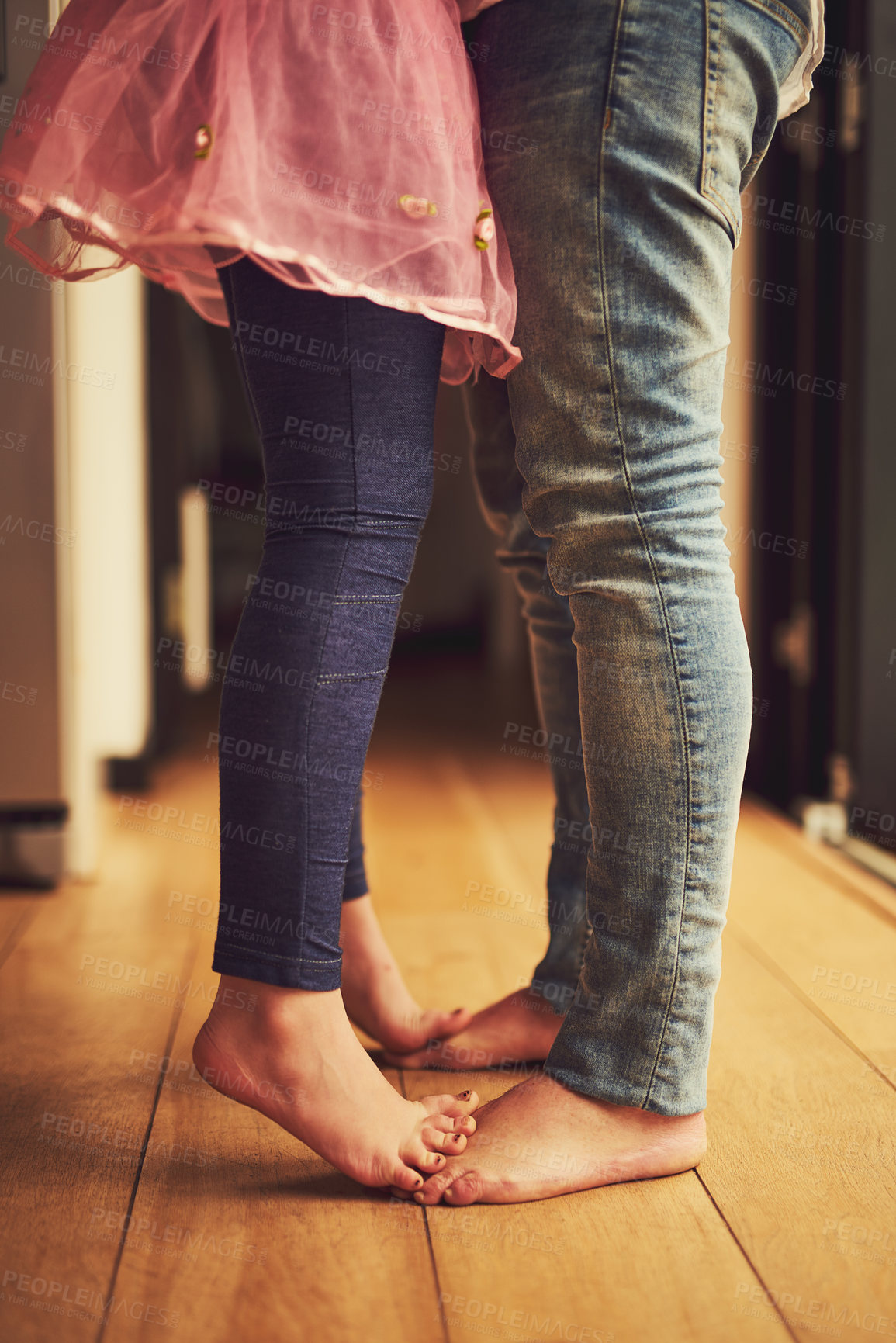 Buy stock photo Cropped shot of a little girl standing on her father's feet