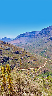 Buy stock photo Landscape, mountains and blue sky with road in nature for environment, horizon and travel. Sustainability, plants and tourism with outdoor path for rocks, habitat conservation and hills background