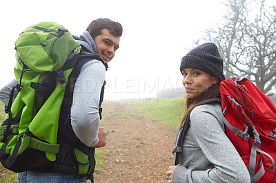 Buy stock photo Rearview shot of a young couple hiking along a nature trail