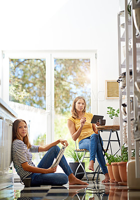 Buy stock photo Relax, portrait and sisters in kitchen with coffee for morning bonding and happy relationship. Women, twins and weekend chat with newspaper, tablet and sitting together in home for social connection.