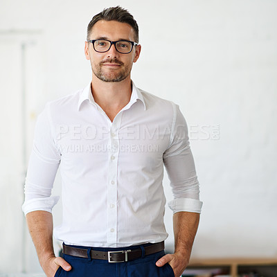 Buy stock photo Cropped portrait of a businessman standing with his hands in his pockets in the office