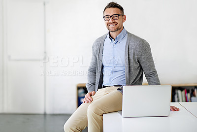 Buy stock photo Cropped portrait of a businessman using a laptop while sitting on his office desk