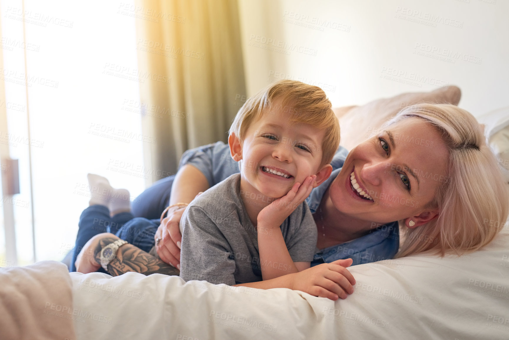 Buy stock photo Mom, boy child and relax on bed in family home for love, happiness and care in apartment. Woman, son and mothers day celebration in bedroom with hug, gratitude and female parent with kid for break 