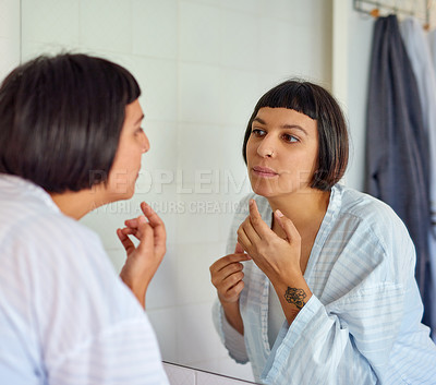Buy stock photo Skincare, woman and mirror reflection in bathroom for grooming, morning routine and acne breakout. Health, female person and bathrobe with collagen for natural glow or shine for dermatology at home