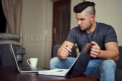 Buy stock photo Man, laptop and table in living room with book, remote work and small online business startup. Technology, planning and paperwork for freelance job at home, entrepreneur or person working on document