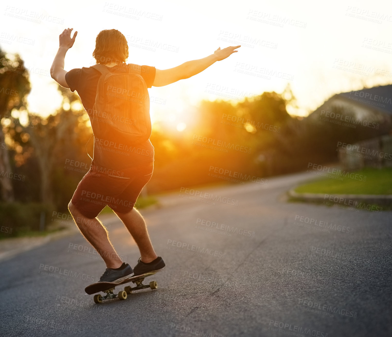 Buy stock photo Young man, back and sport for skateboarding on urban street outdoors for fitness, exercise and fun. Male person or athlete and skating with backpack in sunshine for freedom, peace and wellness