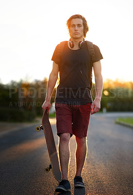 Buy stock photo Portrait of a young man standing with his skateboard outside