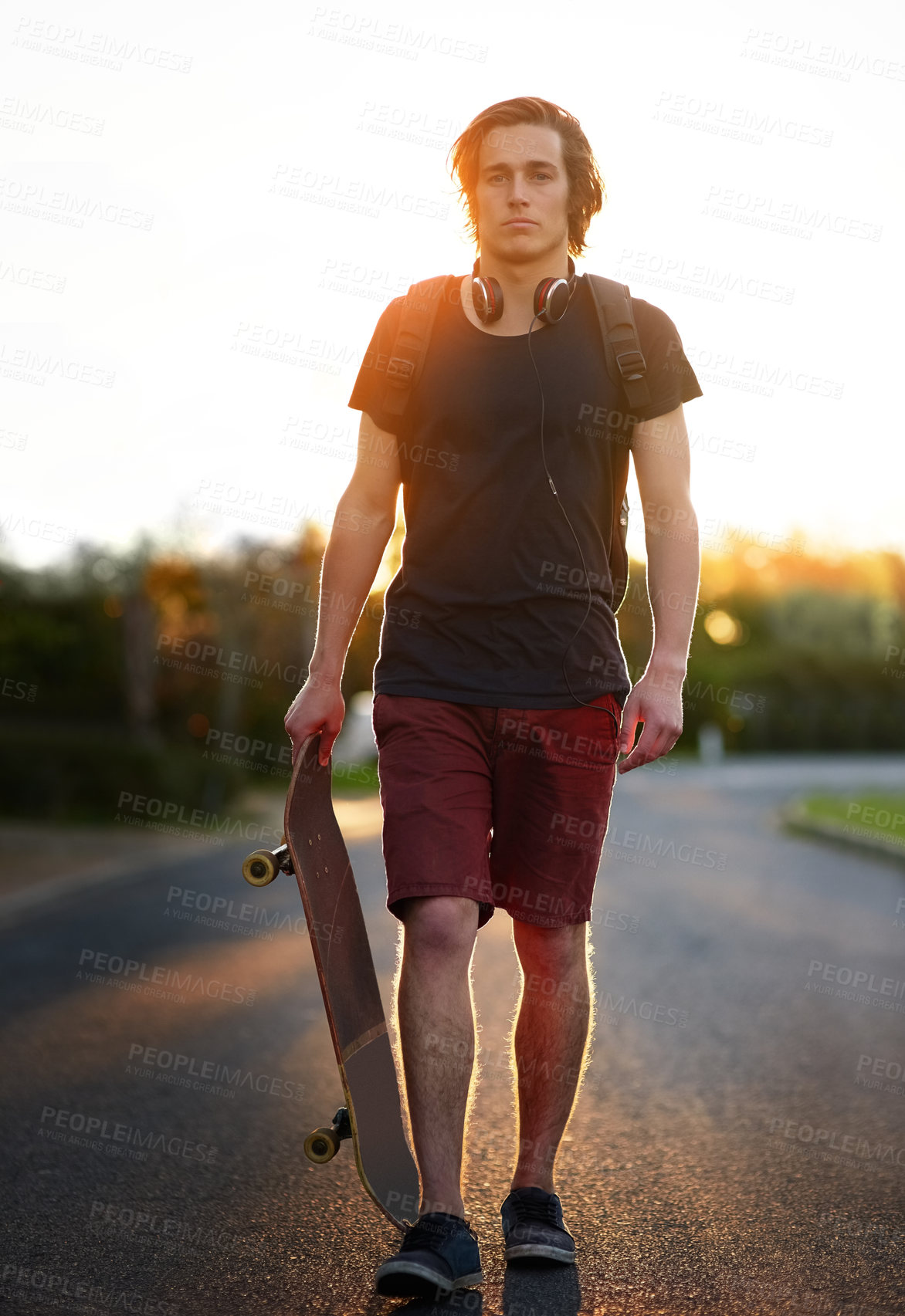 Buy stock photo Portrait of a young man standing with his skateboard outside