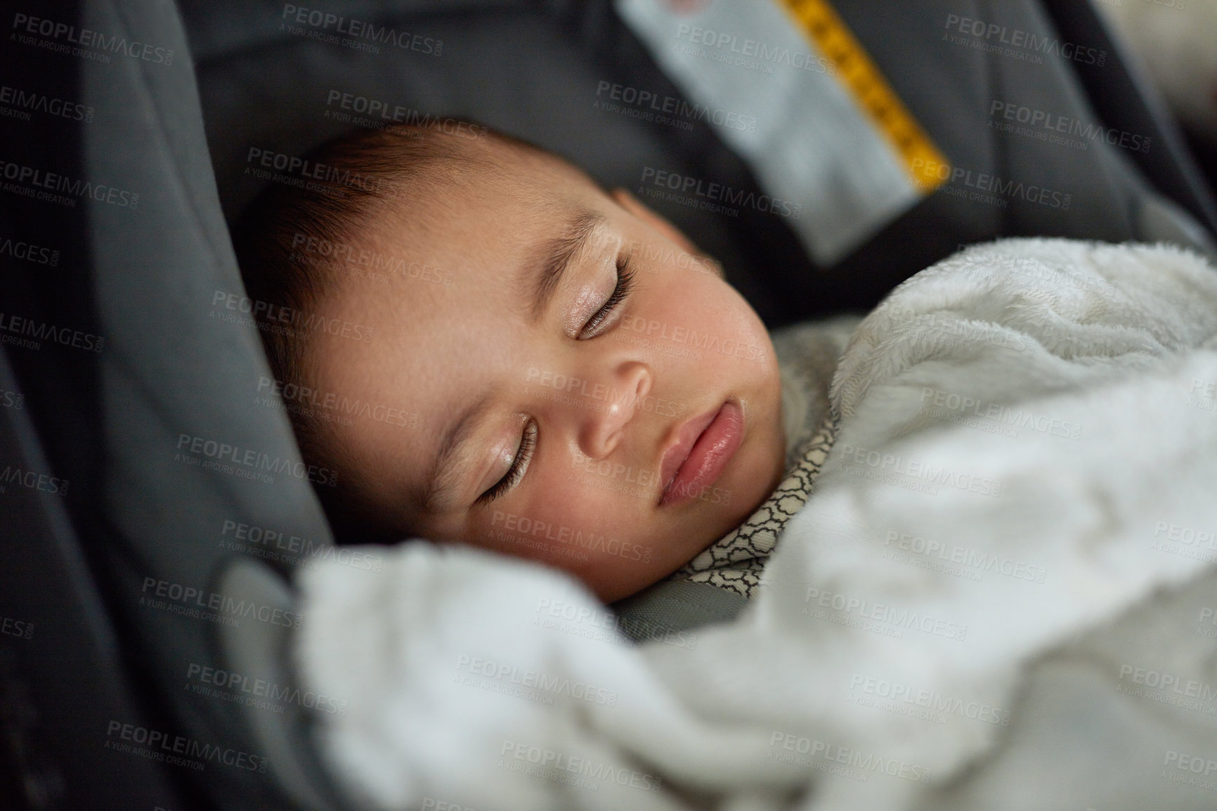 Buy stock photo Shot of an adorable baby boy sleeping in a car seat