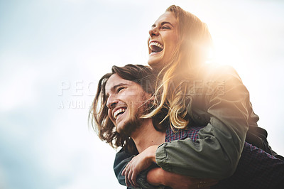 Buy stock photo Shot of a happy young couple having fun outside