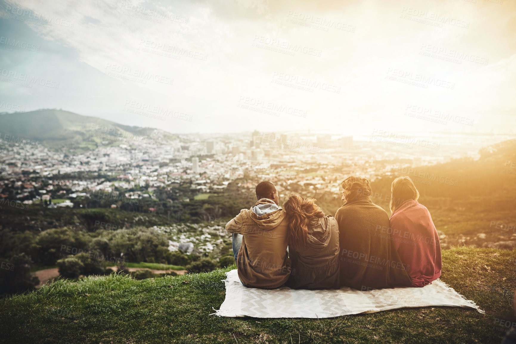 Buy stock photo Friends, picnic and back of people on mountain with view on holiday, vacation and adventure outdoors. Travel, group and men and women with blanket for bonding, relax and fun on weekend in nature