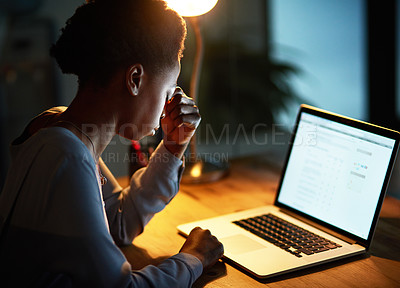 Buy stock photo Cropped shot of a young businesswoman looking stressed out while working late in an office