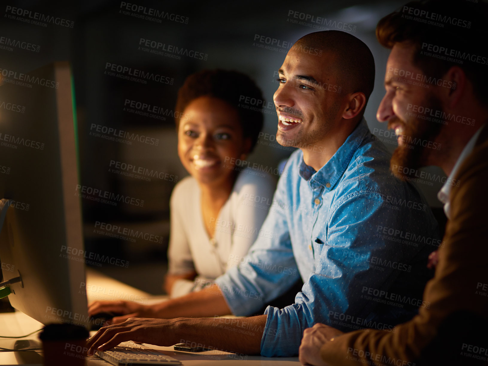 Buy stock photo Cropped shot of a group of colleagues working late in an office